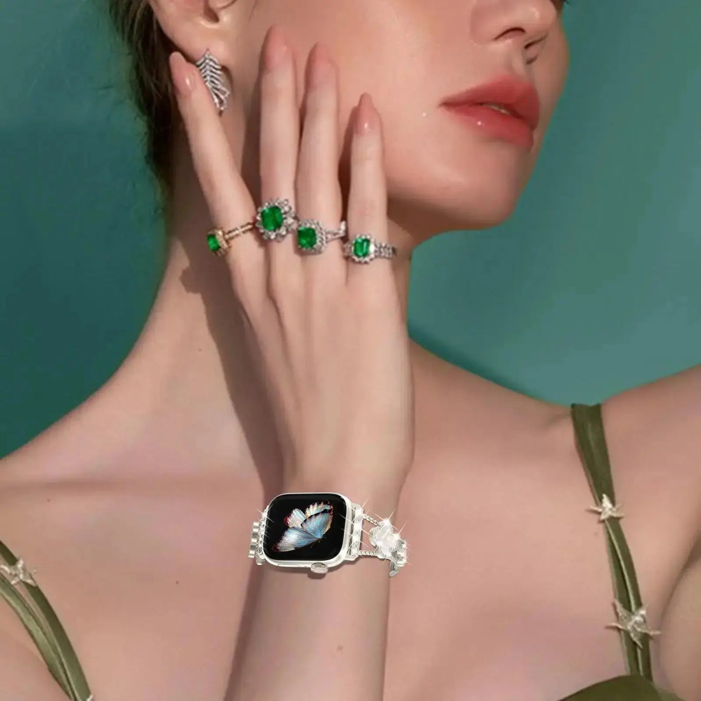 Model showcasing Cristina Bracelet with four-leaf clover design, sparkling rhinestones, paired with elegant green rings.