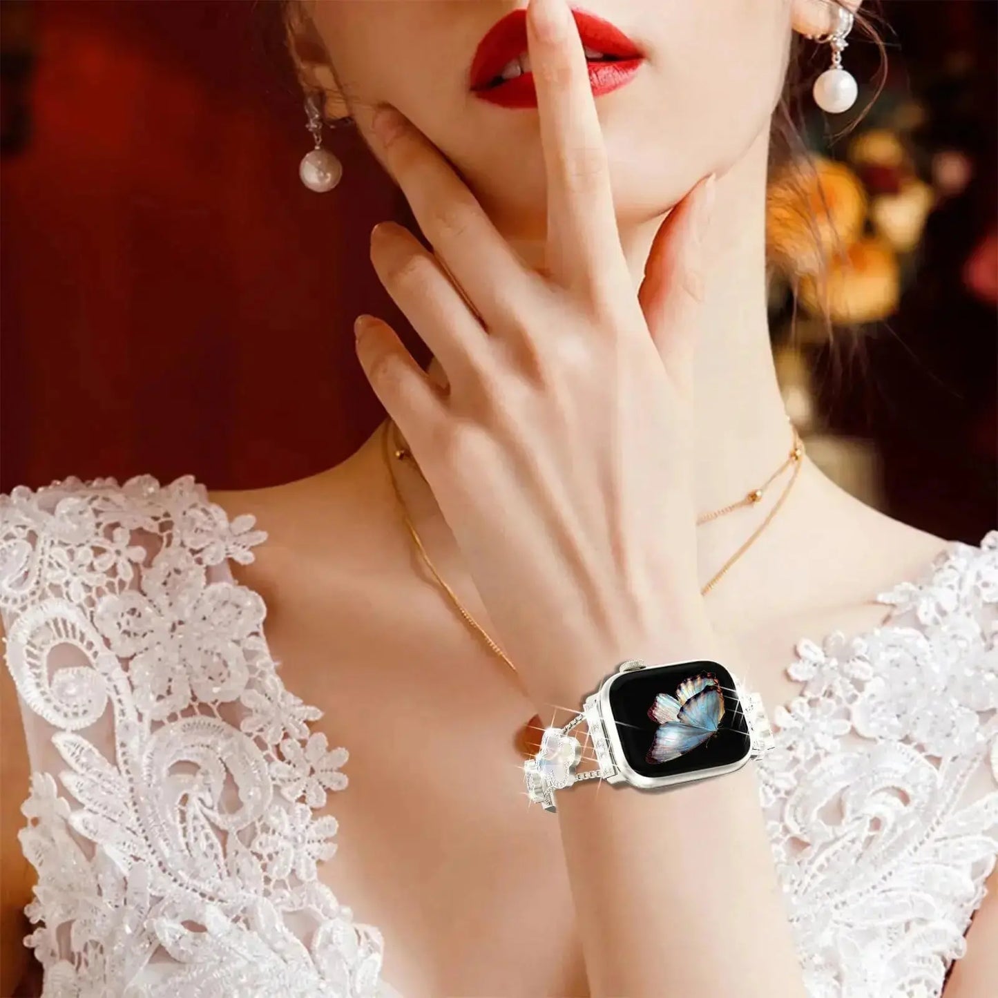 Cristina bracelet on wrist elevating Apple Watch, featuring four-leaf clover design and elegant rhinestones.