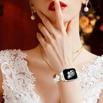 Cristina bracelet on wrist elevating Apple Watch, featuring four-leaf clover design and elegant rhinestones.