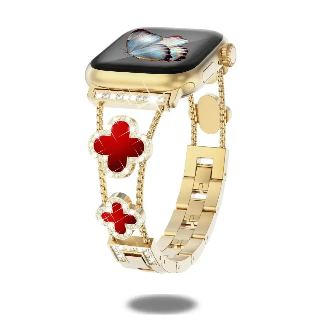Stunning gold Apple Watch bracelet with red four-leaf clover and rhinestone accents, perfect for elegance and style.