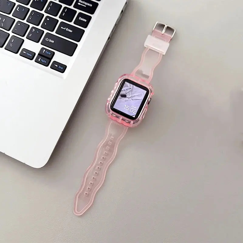 Crystal clear glittery silicone Apple Watch strap and case on a desk next to a laptop, showcasing elegant design.