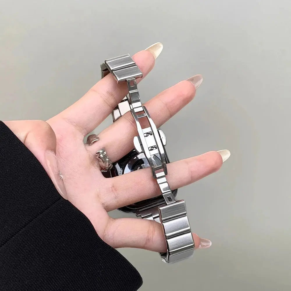 Sleek stainless steel bracelet for Apple Watch held in hand, showcasing elegance and adjustable links for women.