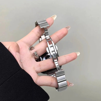 Sleek stainless steel bracelet for Apple Watch held in hand, showcasing elegance and adjustable links for women.