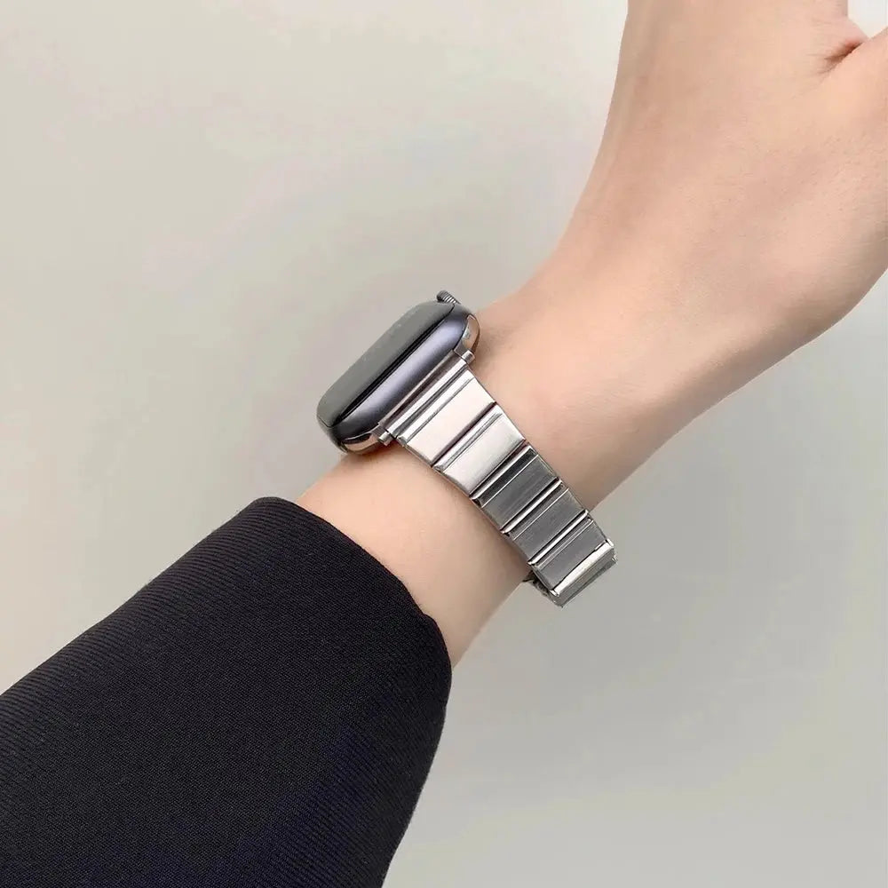 Sleek stainless steel bracelet on wrist, elevating Apple Watch with elegant, polished finish for women.