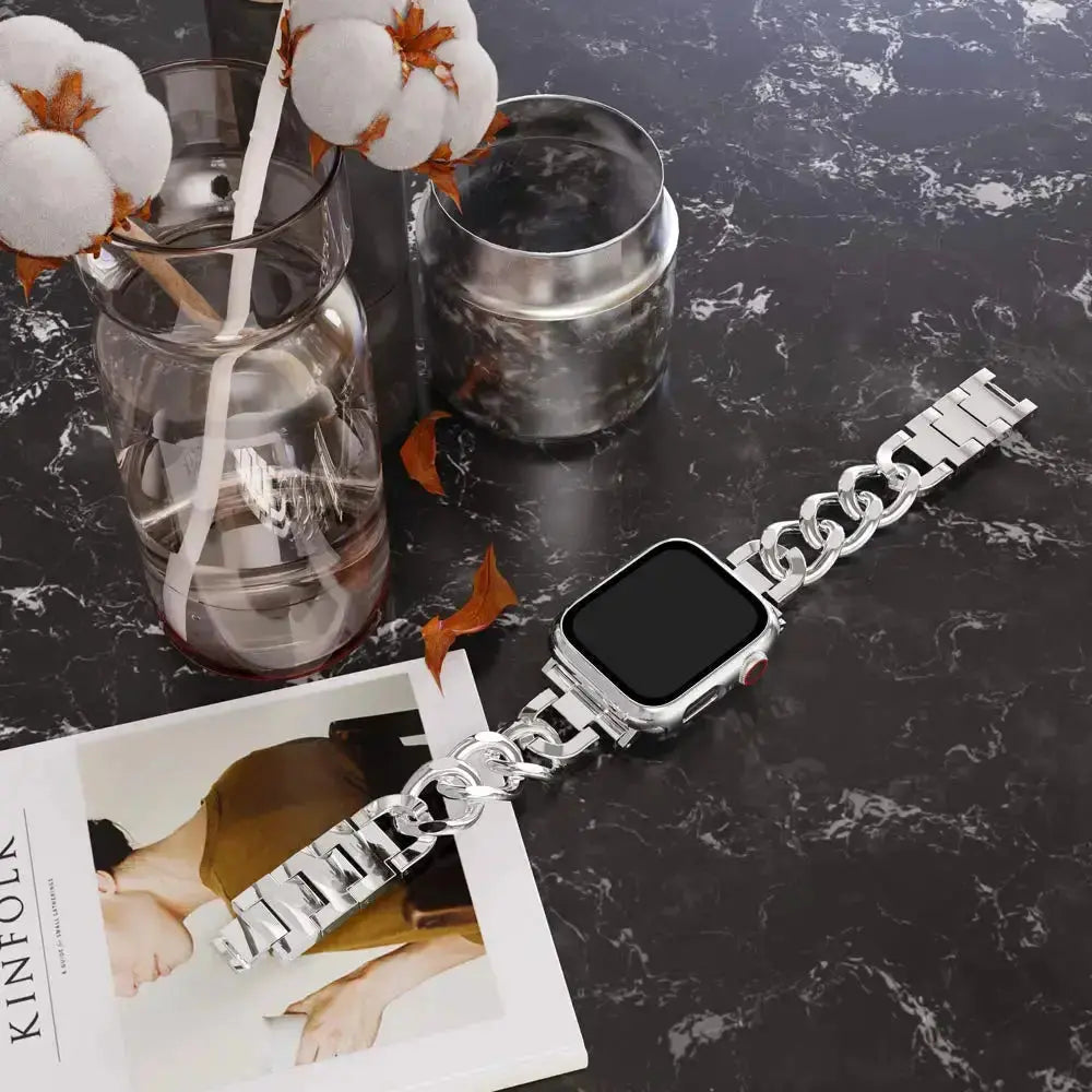 Luxury Cuban bracelet for Apple Watch in silver, showcasing chunky chain design on a stylish tabletop.