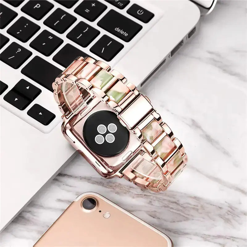 Luxury metal resin strap on a laptop with a marble background, combining elegance and style for modern wear.