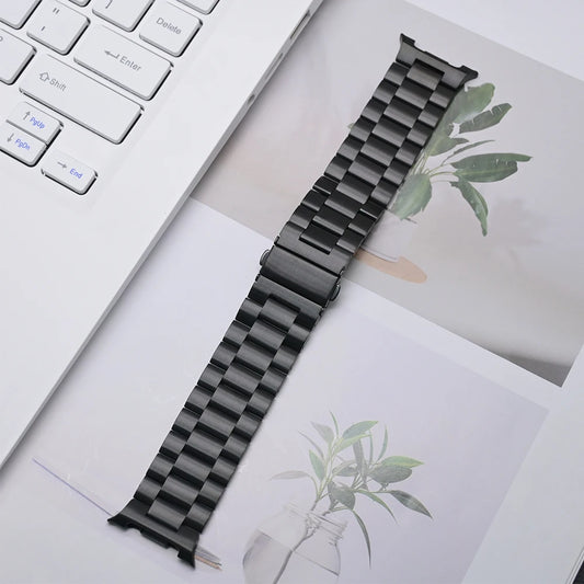 Luxury Stainless Steel Band for Galaxy Watch 8 & 8 Classic displayed on a desk next to a laptop.