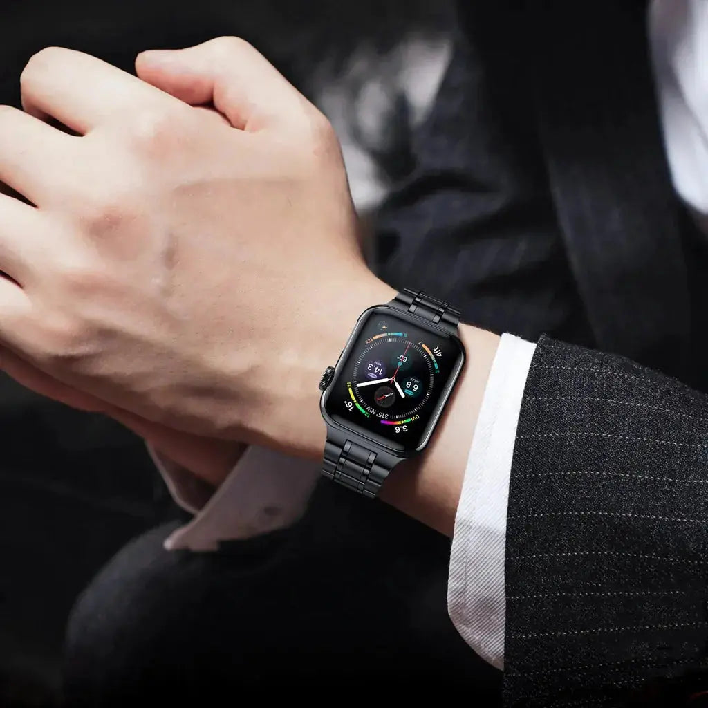 Man wearing a Modern Stainless Steel Link Bracelet on an Apple Watch, showcasing style and elegance.
