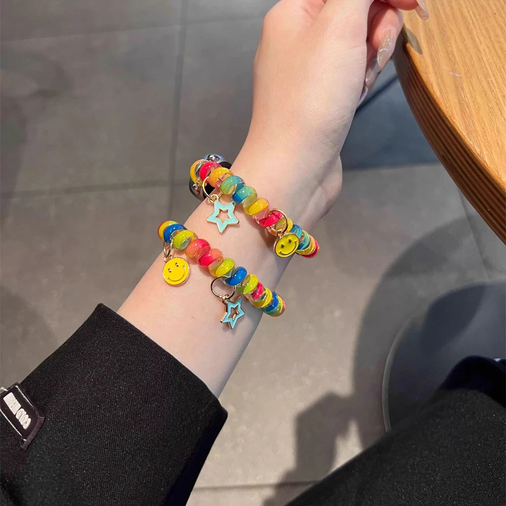 Rainbow Scrunchie Bracelet Apple Watch Band 38–49mm – Elastic Charm Strap worn on wrist showcasing colorful design and charms.