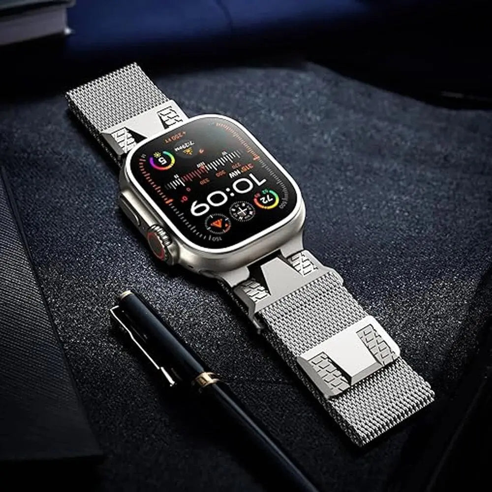 Stylish Alpha Loop Apple Watch band with Milanese Loop design on a desk with a pen, showcasing sophistication and technology.