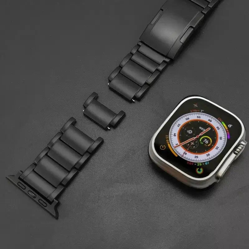 Titanium link bracelet next to an Apple Watch, showcasing durability and style for everyday wear.