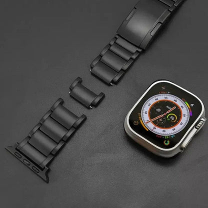 Titanium link bracelet next to an Apple Watch, showcasing durability and style for everyday wear.