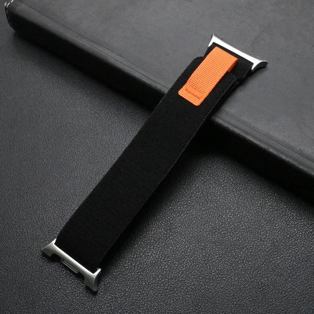 Travel Nylon Sport Loop Band for Galaxy Watch 8 & Ultra 47mm in black with orange accent on a dark background.