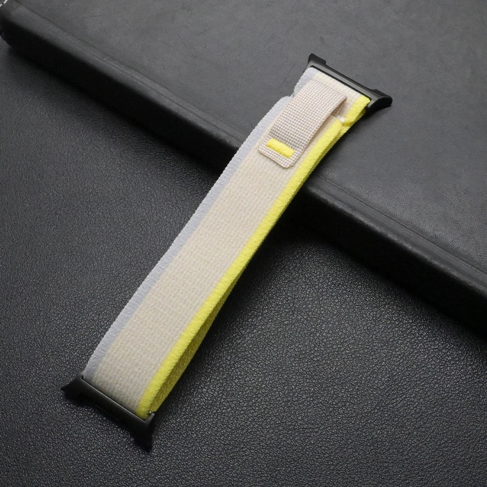 Travel Nylon Sport Loop Band for Galaxy Watch 8 & Ultra 47mm in beige and yellow color on a black surface.