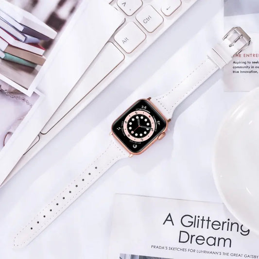 Slim white leather band for Apple Watch, featuring durable stainless steel connectors, stylish and comfortable for fitness tracking.