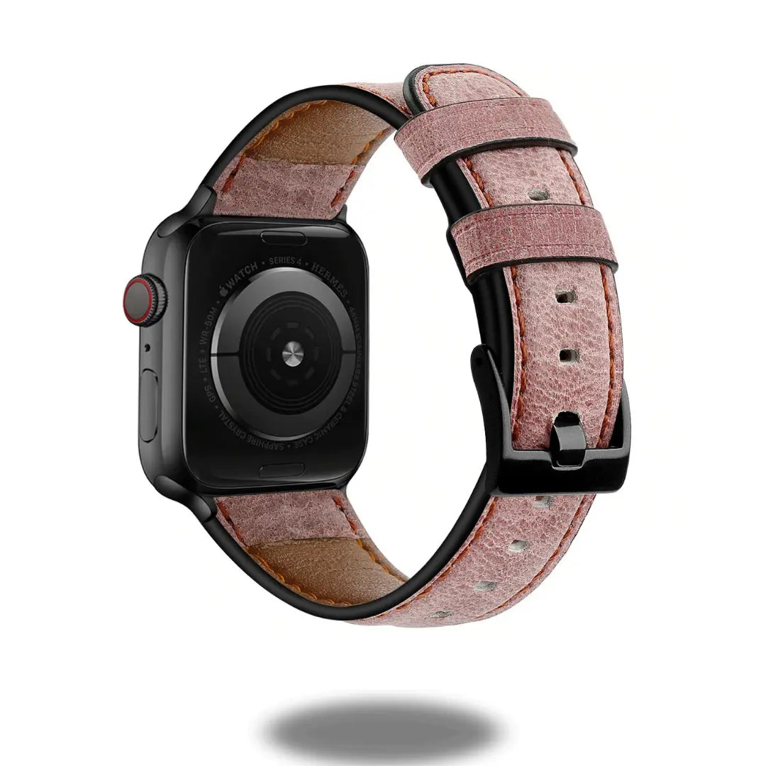 Retro style leather Apple Watch strap in pink, featuring stainless steel connectors and a secure fit.